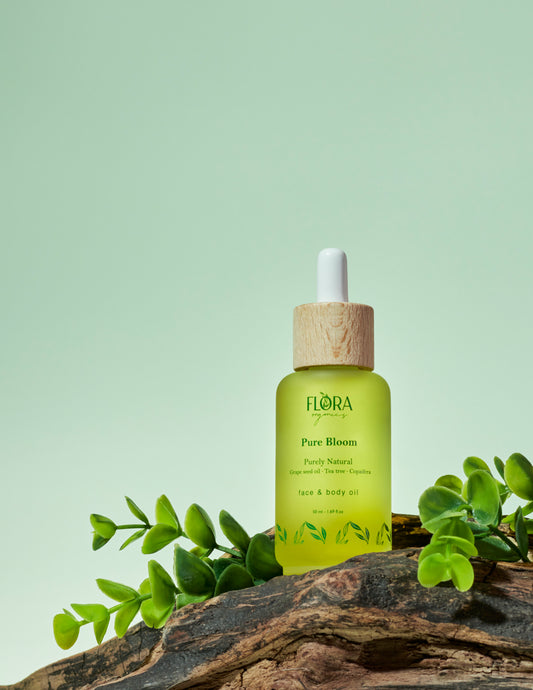 Face and body oil on top of a tree branch, surrounded by leafs