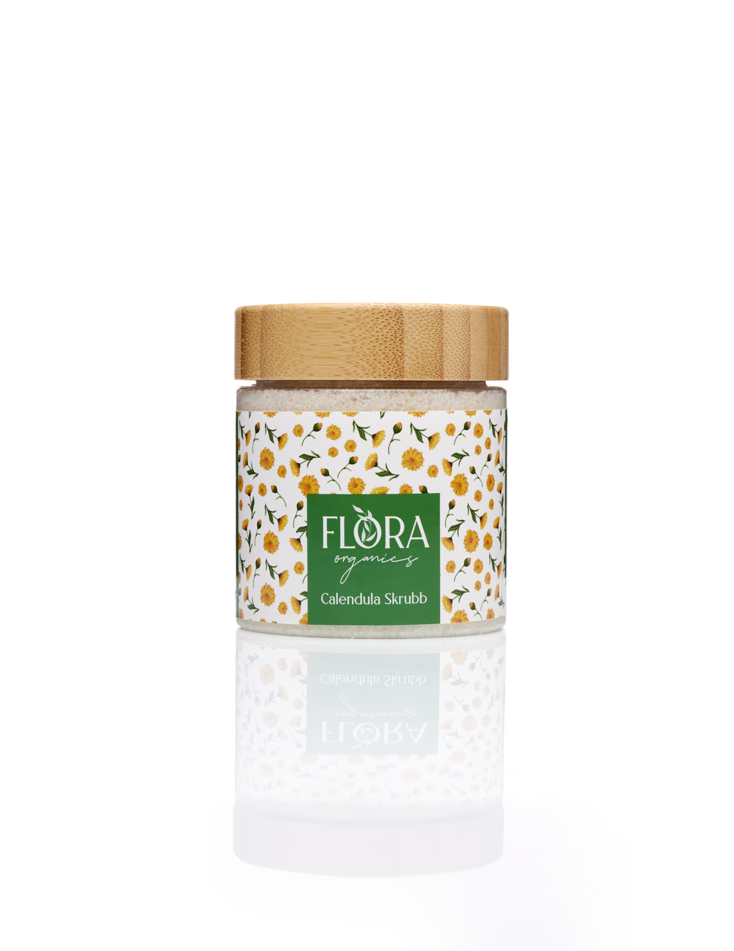 Flora Organics Calendula Scrub in glass jar with bamboo lid, reflected on white background